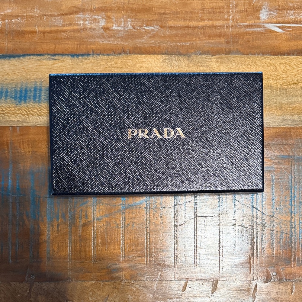 Prada Box- dimensions: 8.5” long x 5” wide x 2” tall.